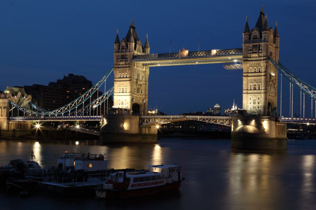 A stunning night view of Londons Tower Bridge illuminated over the River Thames.