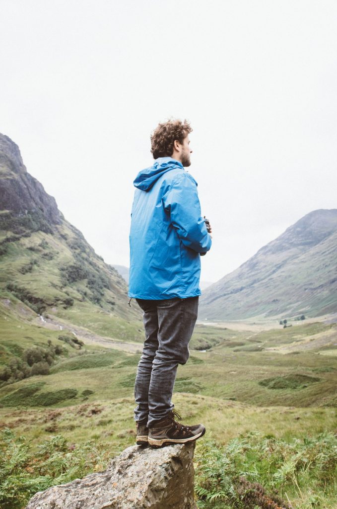 man-standing-on-rock-looking-through-mountain-2f3kee6epqy