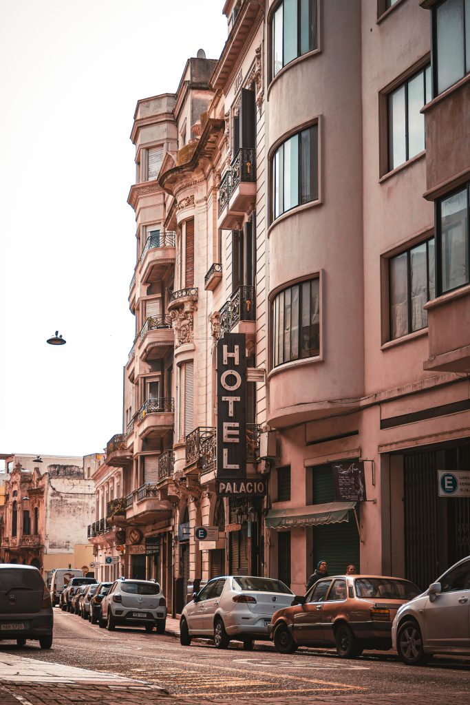 A picturesque urban street lined with classic architecture and parked cars in Uruguay.